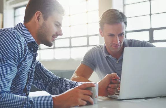 Two men, laptop