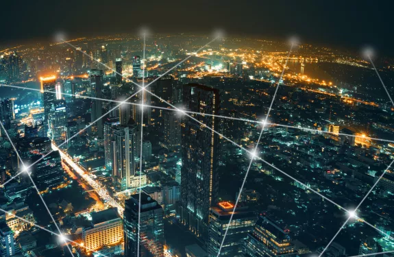 City landscape covered by a grid of connected white dots to symbolize a digital network 