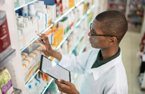 Pharmacist checking shelves