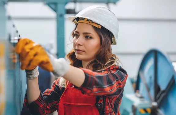 Woman working wearing hard hat
