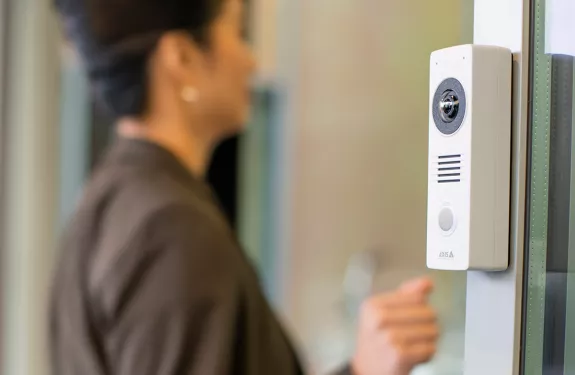 Woman walking through hotel entrance 