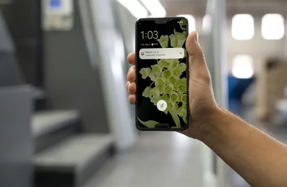 person showing a phone with a notification
