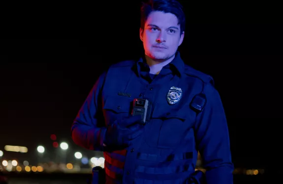 Police officer wearing body worn camera at night