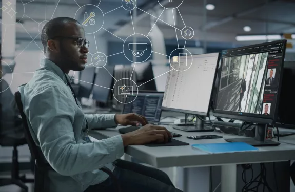 Man in front of monitor showing AXIS Secure Entry interface