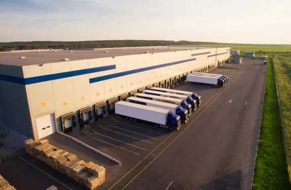 Logistics warehouse with lorries at the front