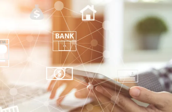 Image of a man checking his phone surrounded by banking and analytics symbols