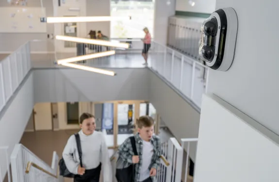 School staircase and hallway with network camera mounted on the wall