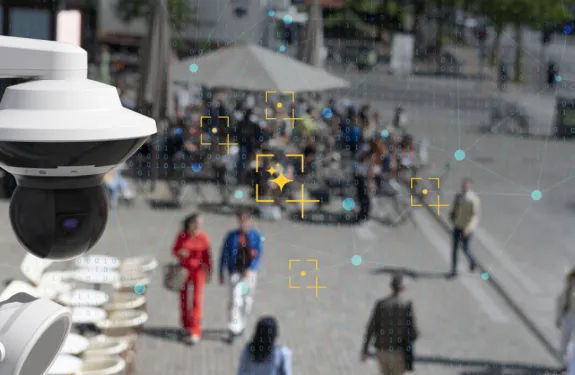 An Axis camera is shown in a busy city with an analytical overlay.