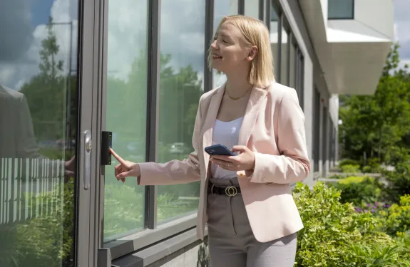 Women using an access control system mounted on a business building