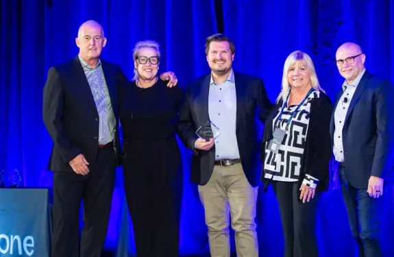 Axis representatives celebrate winning a Milestone award.