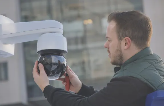 Man performing security camera maintenance