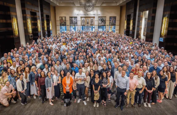 Over 700 employees from across the Americas gather together in a hotel foyer
