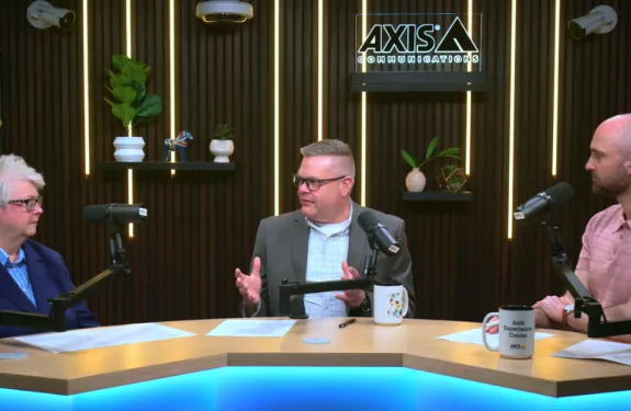 Industry experts discuss modern security during the filming of a podcast.