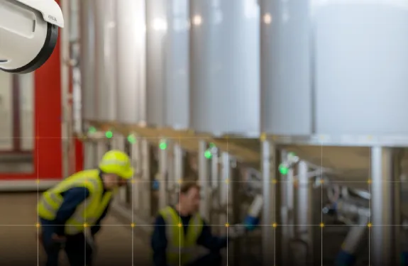 A camera looks on as workers investigate critical machinary.
