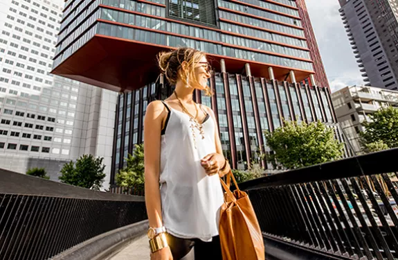 woman_pedestrian_bridge_buildings_city_skyscrapers_2104_780x371