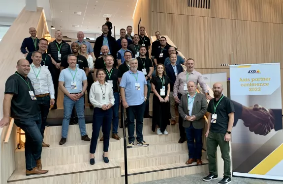 Axis channel partners standing on stairs in HQ