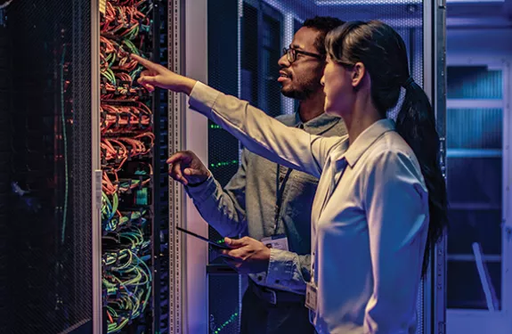 man_woman_pointing_server_racks