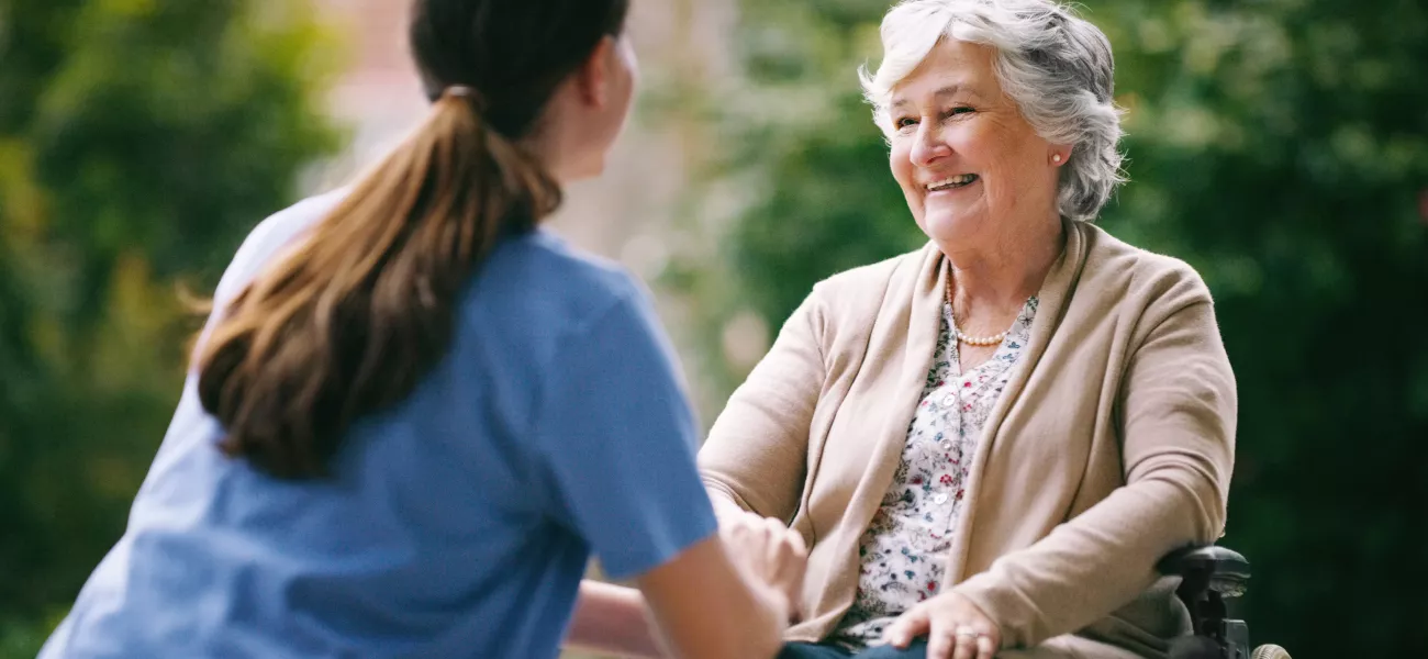 Elderly woman being assisted in elderly home by nurse