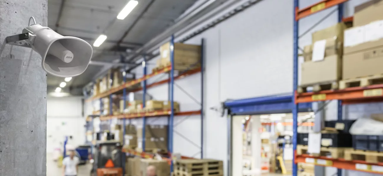 Horn speaker in upper corner of a warehouse