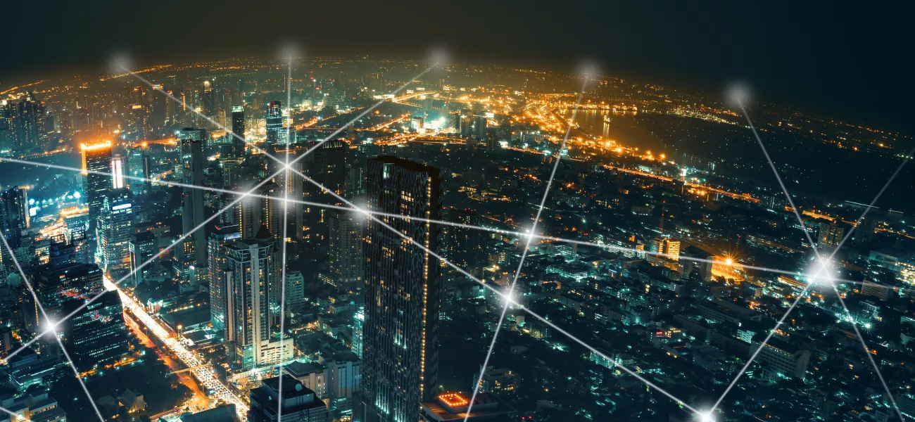 City landscape covered by a grid of connected white dots to symbolize a digital network 