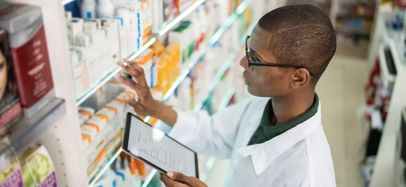 Pharmacist checking shelves