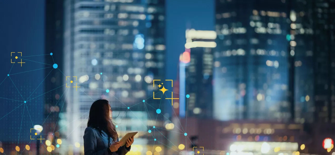 Women holding a device looking at the city