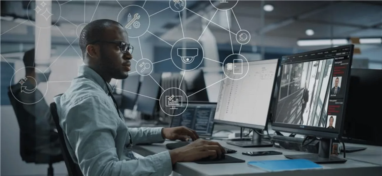 Man at a desk looking at two computer screens