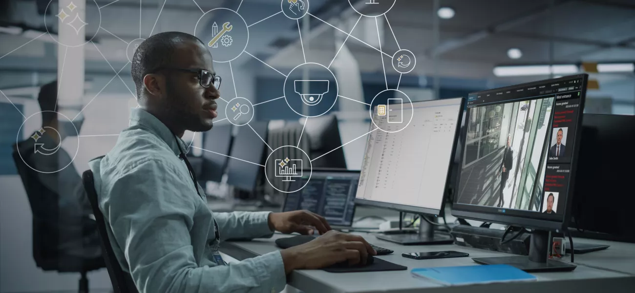 Man in front of monitor showing AXIS Secure Entry interface