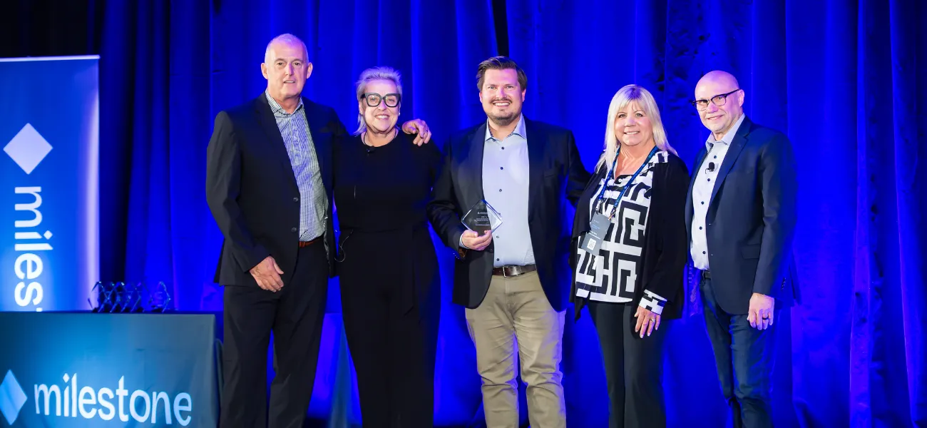 Axis representatives celebrate winning a Milestone award.