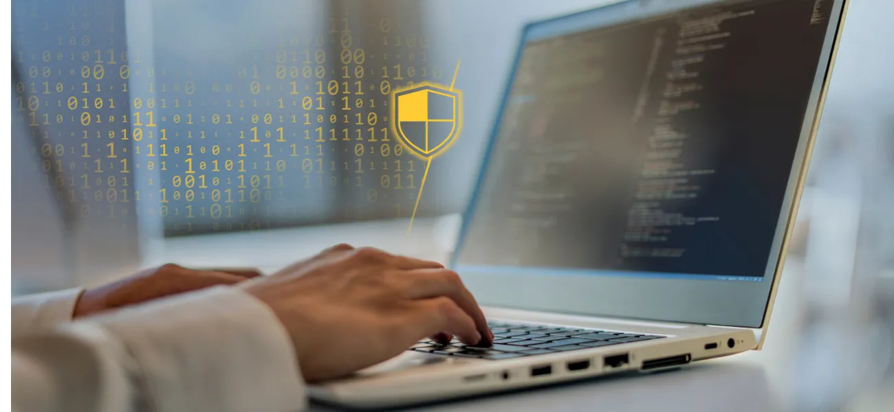 Person typing on computer, with an overlay of cybersecurity symbols.