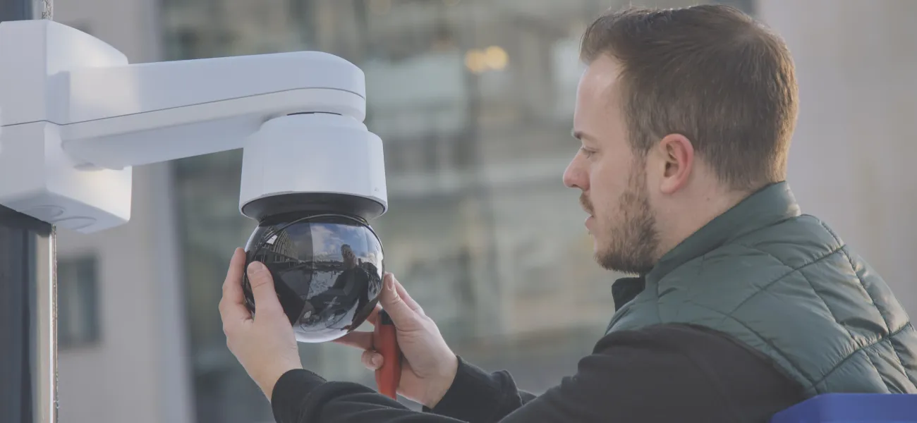 Man performing security camera maintenance