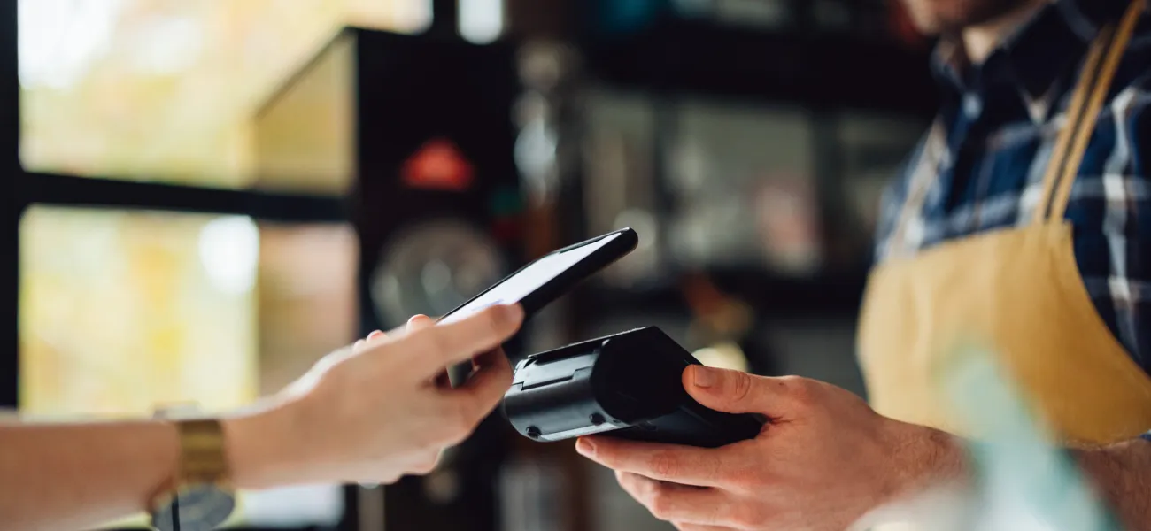 Woman paying with her phone