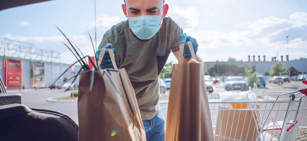 Man in mask shopping