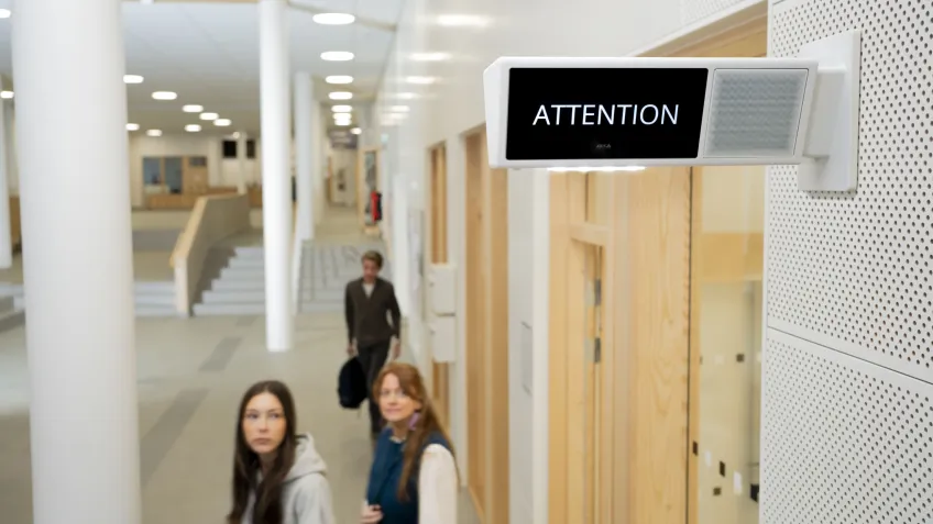 Two students looking at a sign calling for attention in a possible school lockdown event