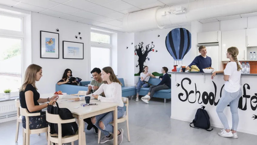Students in a school cafeteria equipped with school lockdown solutions
