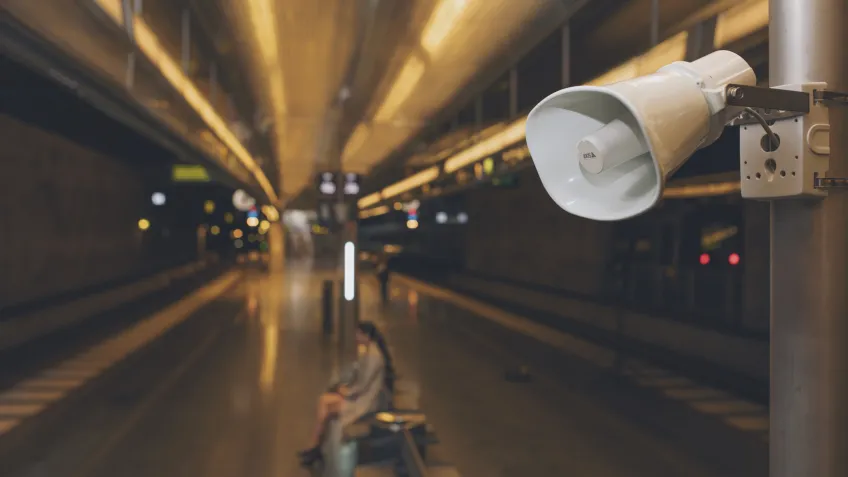 An outdoor PA speaker installed at a train station
