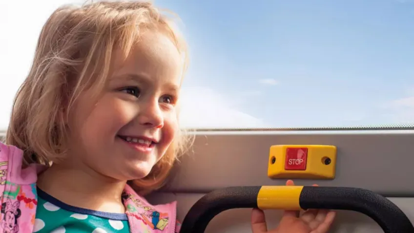 Girl riding a Nobina bus which uses a transit bus camera system