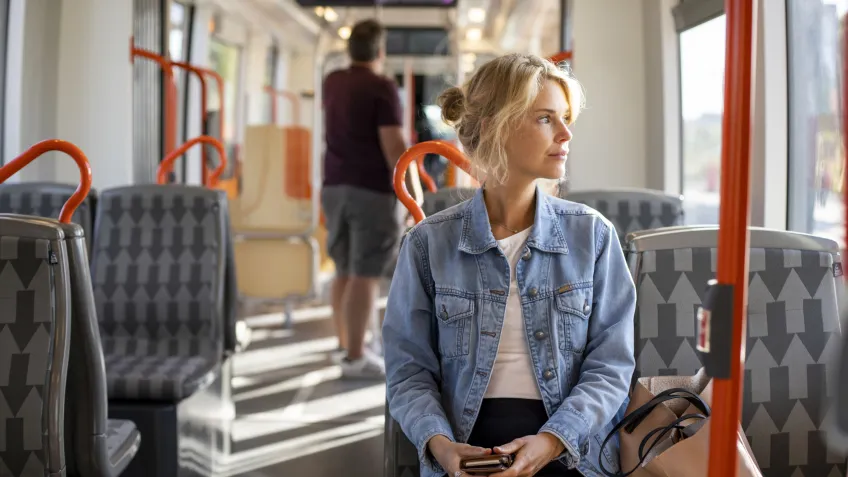 Woman riding a train which uses rail surveillance
