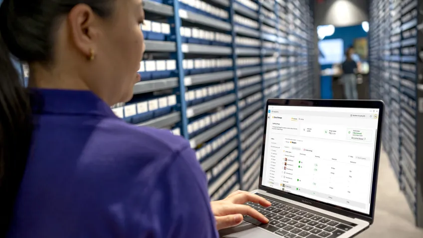 Woman holding a computer in a data storage facility