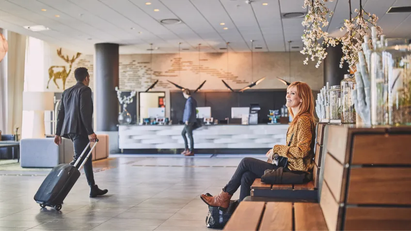 Two guests in a hotel lobby.