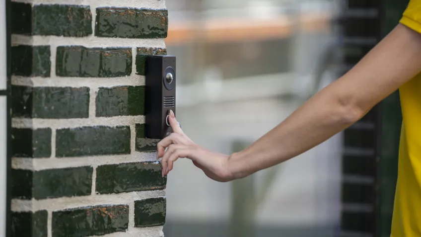 Woman using her fingerprint to access a building