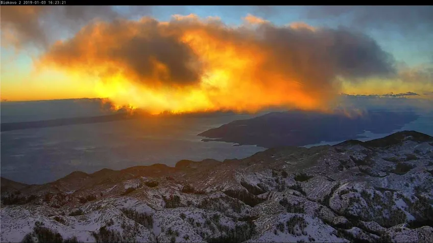 Sunset by a mountain