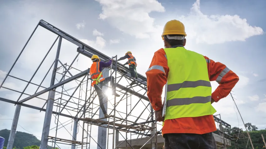 Construction worker wearing a vest and hardhat